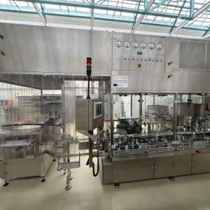 Optima Limoline filling and capping machine for plastic bottles with screw caps, including Franz Ziel laminar flow hood and BBK labelling machine